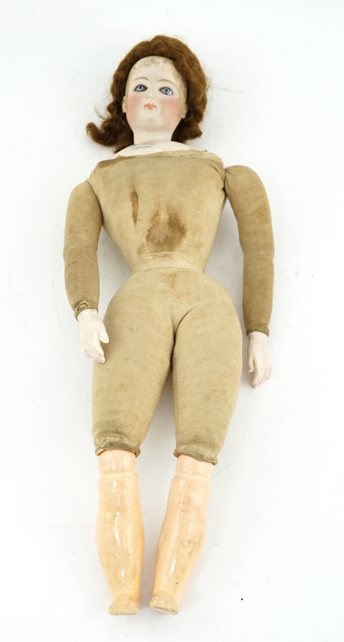 A late 19th century French biscuit head doll, possibly Simon & Halbig, with cloth body, bisque hands, 45cm high, eye and ear chip